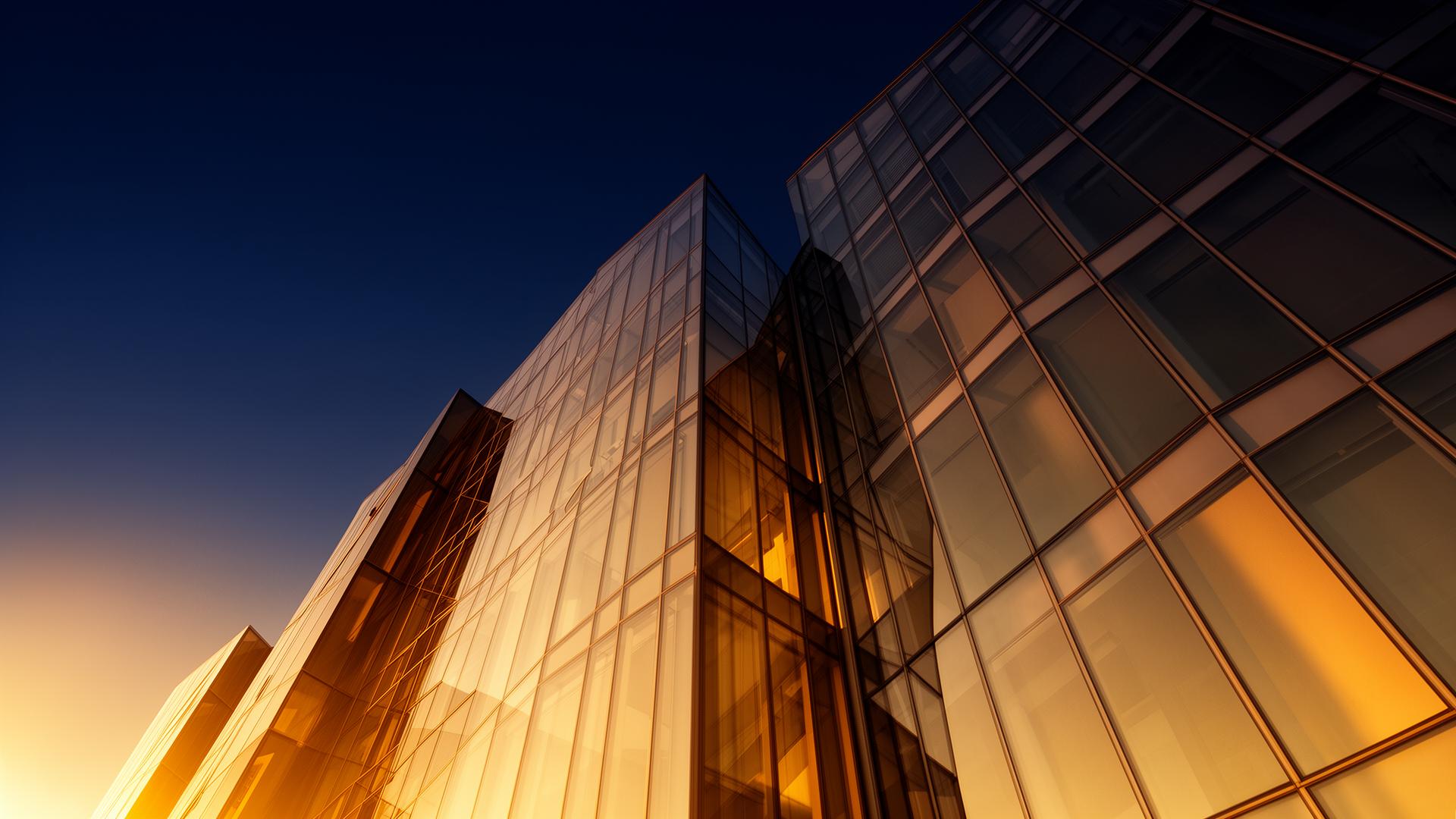 Modern glass curtain wall façade at dusk